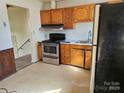 A functional kitchen featuring stainless steel appliances and wood cabinets, ready for your culinary adventures at 1608 Carfax Dr, Charlotte, NC 28216