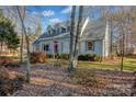 Two-story light gray house with mature trees at 161 Picwyck Dr, Mooresville, NC 28115