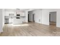 Modern white kitchen with island and stainless steel appliances at 250 Franklin Nw Ave, Concord, NC 28025