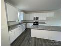 Modern kitchen with white cabinets, granite countertops, and stainless steel appliances at 2583 Watson Dr, Lancaster, SC 29720