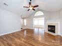 Spacious living room with hardwood floors, fireplace, and sunroom access at 2748 Polo Club Blvd # 2, Matthews, NC 28105