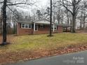 Ranch style brick home with a large yard and mature trees at 315 S Morrow Ave, Albemarle, NC 28001