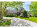 Beautiful home with a curved driveway and lush, mature landscaping at 4150 Summit Ridge Ln, Denver, NC 28037