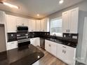 Modern kitchen with white cabinets and dark countertops at 440 Steeplechase Trl, Salisbury, NC 28144