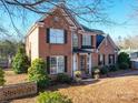 Two story brick home with landscaping and a walkway at 6922 Concord Hwy, Monroe, NC 28110