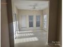 Bright sunroom with multiple windows and tile flooring at 8726 Castle Cliff Dr, Matthews, NC 28105