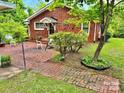 Brick ranch house with patio, landscaping, and a spacious yard at 931 Skyline Dr, Chester, SC 29706