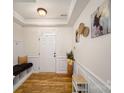 Bright entryway with wood floors, bench seating, and tasteful wall art at 11315 Savannah Creek Dr, Charlotte, NC 28273