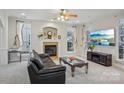 Inviting living room featuring a fireplace, large windows, and comfortable seating, perfect for relaxation at 13123 Meadowmere Rd, Huntersville, NC 28078
