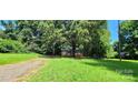 Small house on a grassy lot with a gravel driveway at 3169 Eden Terrace Ext, Rock Hill, SC 29730