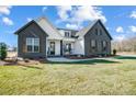 Gray brick two-story house with white accents and a welcoming front porch at 3436 Greene Rd, Monroe, NC 28110