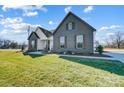 Contemporary farmhouse exterior with gray brick, white accents, and landscaping at 3436 Greene Rd, Monroe, NC 28110