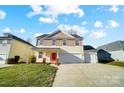 Two-story house with a two-car garage and a well-manicured lawn at 4005 Linville Falls Ln, Monroe, NC 28110