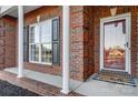 Brick front porch with columns and a red door at 5517 Cyrus Lee Ln, Monroe, NC 28110
