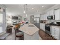 Open concept kitchen with island and stainless steel appliances at 9113 Meadowmist Ln, Huntersville, NC 28078