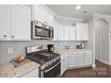 Modern kitchen with stainless steel appliances and white cabinets at 9113 Meadowmist Ln, Huntersville, NC 28078