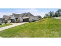 Home's exterior showcases a side view of the home with landscaping and driveway at 917 Black Beard Dr, Denver, NC 28037