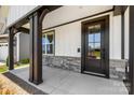 Front entrance with black door and stone accents at 917 Black Beard Dr, Denver, NC 28037