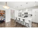 Bright, white eat-in kitchen with modern appliances, spacious island and stylish pendant lighting at 144 Mooring Dr, Statesville, NC 28677