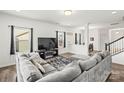 Spacious living room featuring a large sectional sofa, modern fireplace and views of the backyard at 144 Mooring Dr, Statesville, NC 28677