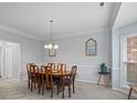 Formal dining room with hardwood floors, chair rail, and chandelier at 2609 Lamp Post Ln, Kannapolis, NC 28081