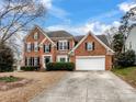 Brick two-story house with attached garage and landscaping at 2609 Lamp Post Ln, Kannapolis, NC 28081