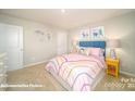 Bright bedroom with a bed, nightstand, and unicorn decor at 3680 Charles Nw St, Conover, NC 28613