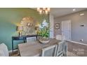 Bright dining room with modern chandelier and accent wall at 3686 Charles Nw St, Conover, NC 28613