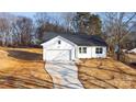 Newly constructed home with white siding and a dark roof at 4119 Pebblebrook Sw Cir, Concord, NC 28027