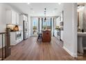 Well-lit kitchen includes a breakfast bar, stainless steel appliances, white cabinetry, and access to a balcony at 5715 Castlerea Dr, Charlotte, NC 28217
