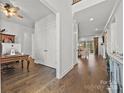 Inviting foyer with hardwood floors and a glimpse of the living room at 7150 Irongate Dr, Indian Land, SC 29707