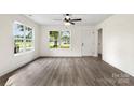 Bright living room with large windows, modern ceiling fan, and beautiful wood-look vinyl flooring at 939 Stonewall S Ave, Rock Hill, SC 29730