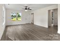 Inviting living room featuring multiple windows, and new wood-look vinyl flooring at 939 Stonewall S Ave, Rock Hill, SC 29730