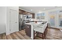 Modern kitchen with stainless steel appliances and a breakfast bar at 1014 Beatty Woods Dr, Belmont, NC 28012