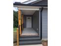 Front entrance with wooden posts and a covered porch at 110 Gilliatt St, Shelby, NC 28150