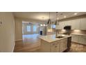 Open kitchen with white cabinets, quartz island, and stainless steel appliances at 135 Ella Claire Dr, York, SC 29745
