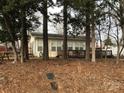 House exterior showcasing a wooden deck and surrounding foliage at 135/137 Indian Harbor Trl # E16/17, Mount Gilead, NC 27306