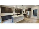 Modern kitchen with dark cabinets, quartz countertops, and stainless steel appliances at 139 Ella Claire Dr # 003, York, SC 29745