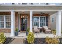 Brick front porch with rocking chairs and landscaping at 14015 Helen Benson Blvd, Davidson, NC 28036