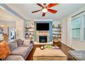 Spacious living room features a stone fireplace and built-in shelving at 14015 Helen Benson Blvd, Davidson, NC 28036