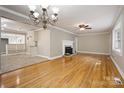 Living room features hardwood floors, fireplace, and kitchen view at 2830 Royston Rd, Charlotte, NC 28208