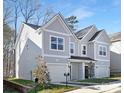 Two-story duplex with gray siding, two-car garages, and landscaping at 3114 Amay James Ave, Charlotte, NC 28208