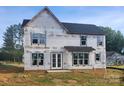 Two-story home under construction featuring a covered porch, black roof, and white window trim at 3215 Player Ct, Salisbury, NC 28144
