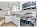 Modern kitchen with white cabinets, stainless steel appliances, and granite countertops at 4032 Dinglewood Ave, Charlotte, NC 28205