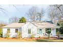 Charming single-story home with light blue door, covered porch, and beautiful landscaping at 711 Concord Rd, Davidson, NC 28036