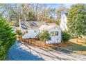 Charming home with updated exterior, fresh paint, mature trees, and black aluminum fence at 711 Concord Rd, Davidson, NC 28036