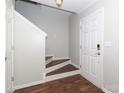 Bright entryway with hardwood floors, staircase, and neutral-colored walls at 7225 Sandown Ct, Harrisburg, NC 28075