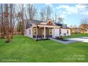 Modern farmhouse exterior, covered porch, and landscaped lawn at 108 Robinson Dr, Cherryville, NC 28021