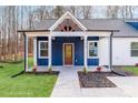 Inviting front entrance of this home, showcasing a striking blue facade, and a covered porch at 108 Robinson Dr, Cherryville, NC 28021