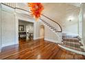 Grand two-story foyer with hardwood floors and curved staircase at 1333 Carlton Ave, Charlotte, NC 28203